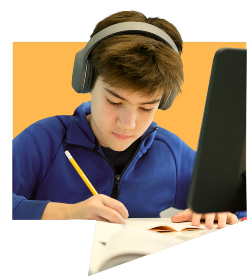 boy writing behind laptop